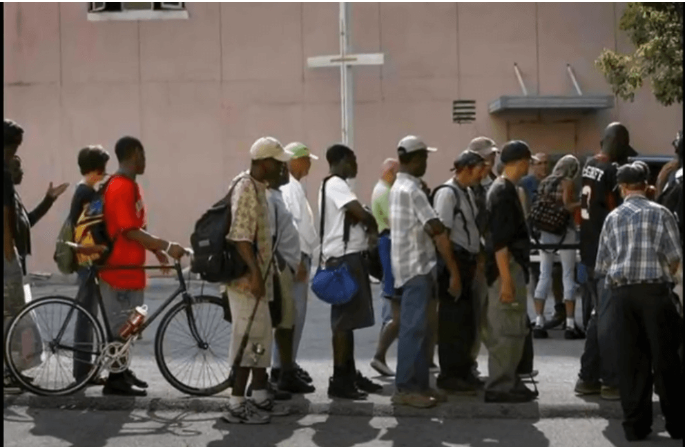 A picture of a homeless Super Heros Palace veterans standing in line for help